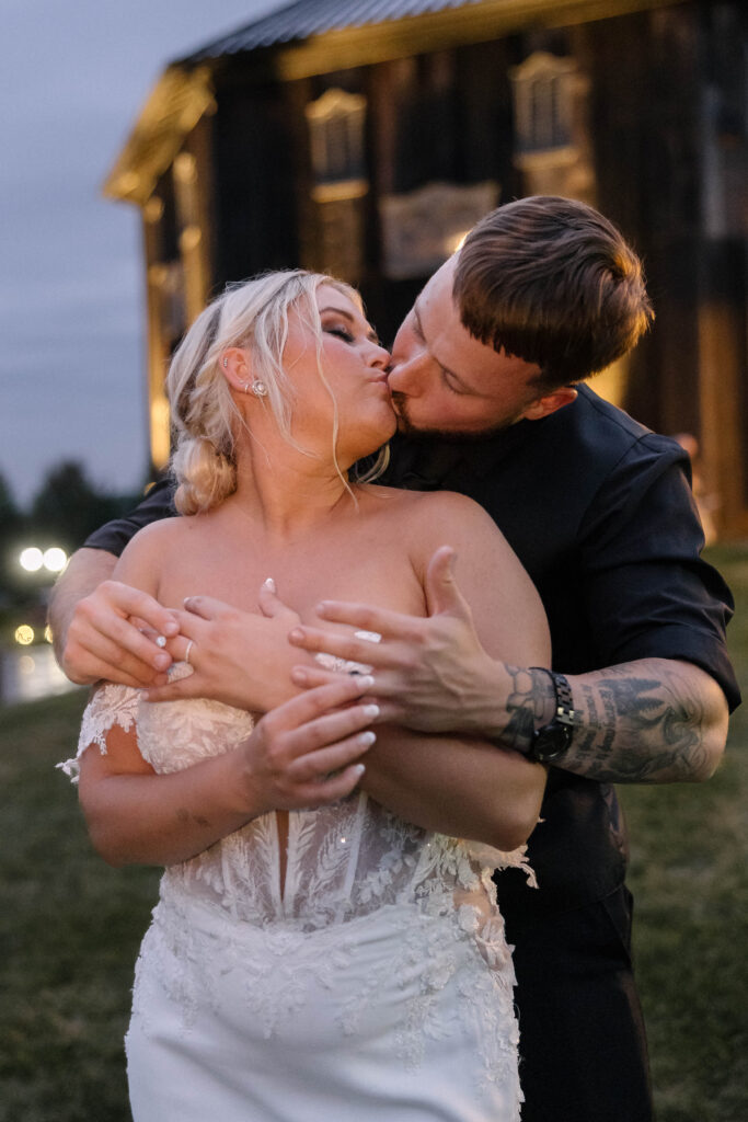 Bride and groom sharing a romantic kiss at the historic 1885 Barn in Ohio, captured by Cleveland-based wedding photographer.