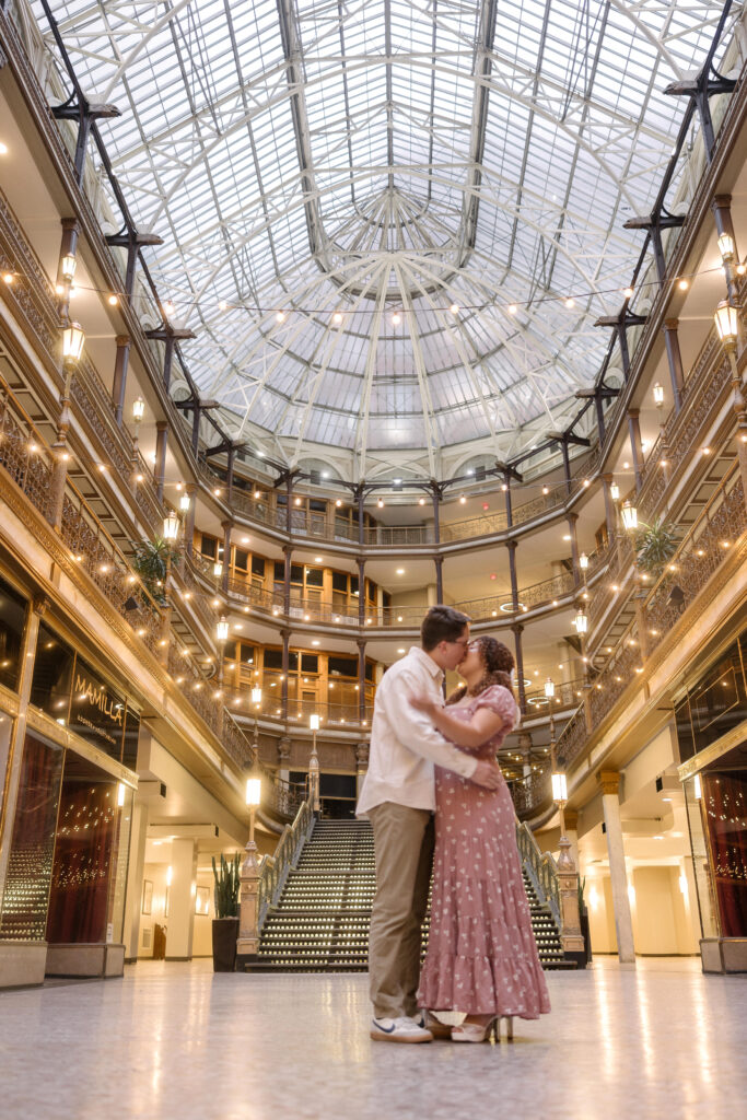 Couple dancing in the historic Old Arcade in Cleveland during their engagement photo session.