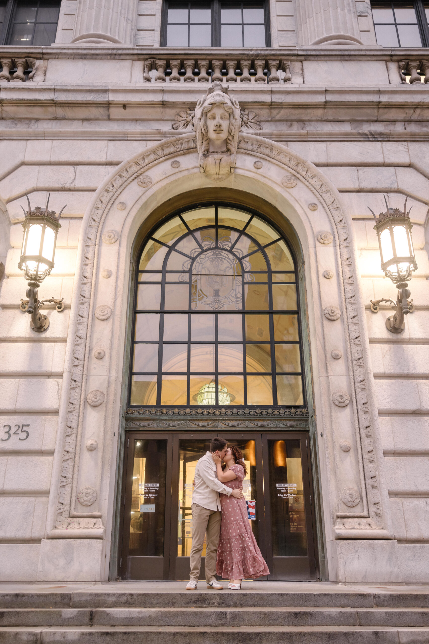 Engagement photo in front of the Cleveland Downtown Public Library, one of the top spots recommended by TheWiz Photography for weddings, quinceañeras, and engagement photography in Cleveland.