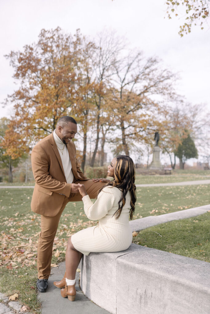 Engaged couple walking hand-in-hand near the Oval Pond at University Circle during their fall engagement session.