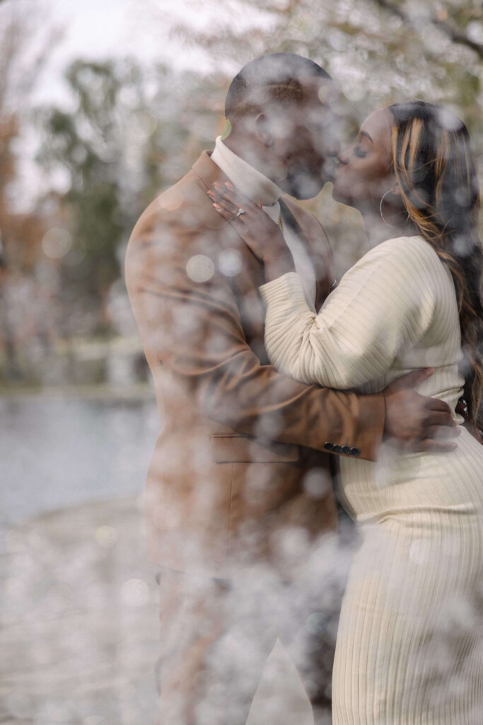 Elegant engagement photo of a couple sharing a tender moment in front of the iconic Cleveland Museum of Art.