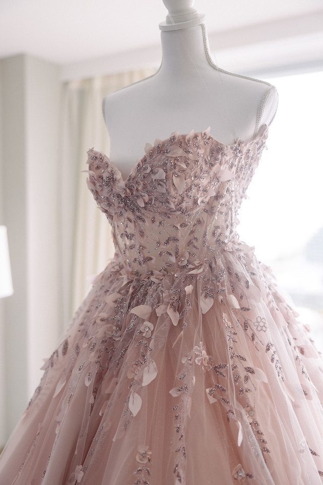 Close-up of floral appliqué and beading on Yariana’s pink quinceañera gown.