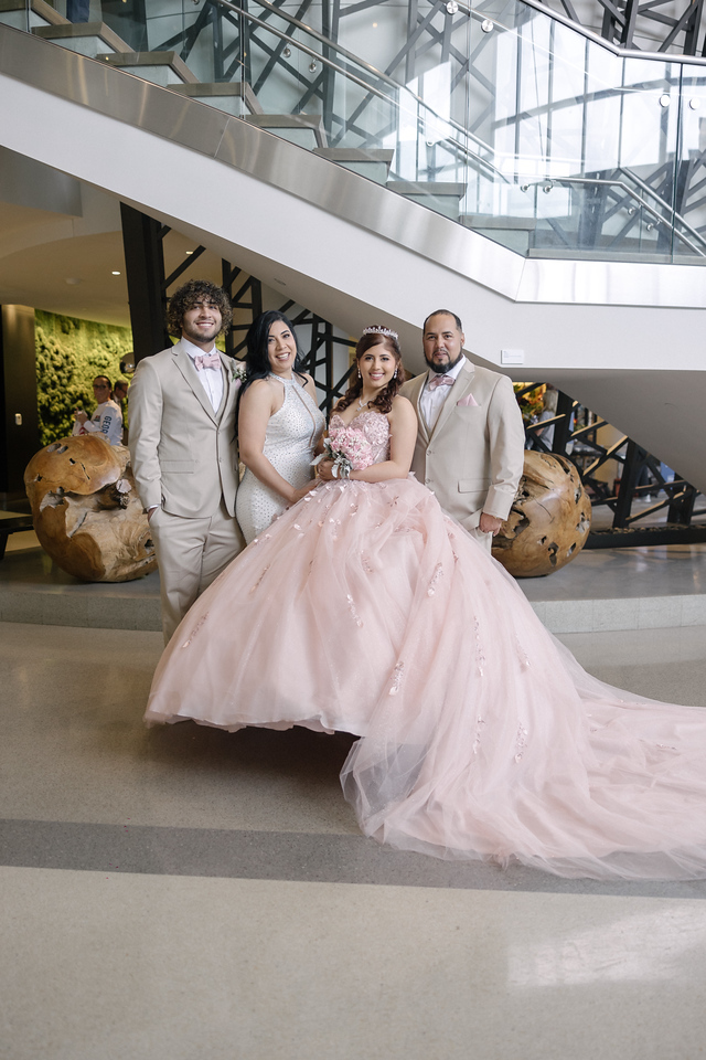 Yariana posing with family in the Hilton hotel lobby.