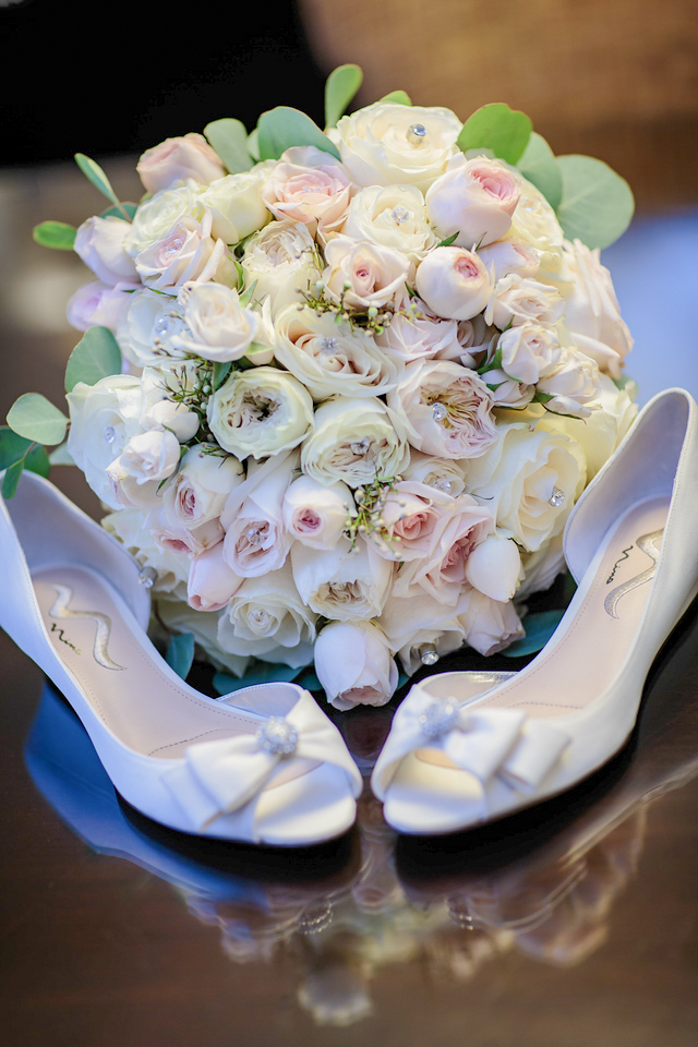 Pale wedding bouquet and bridal shoes
