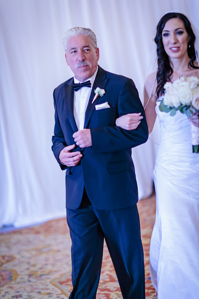 Nicole walking into the ceremony with her escort