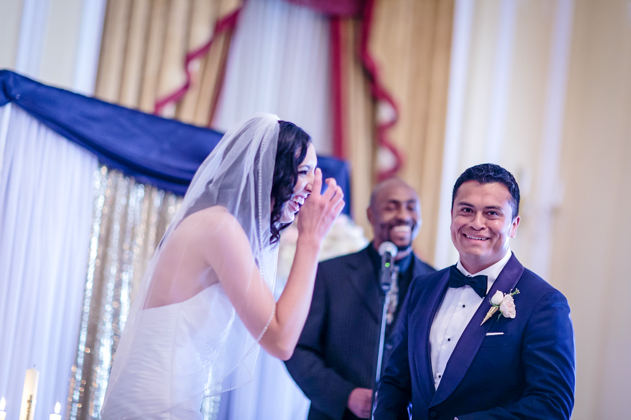 Nicole and Malcolm laughing during their ceremony