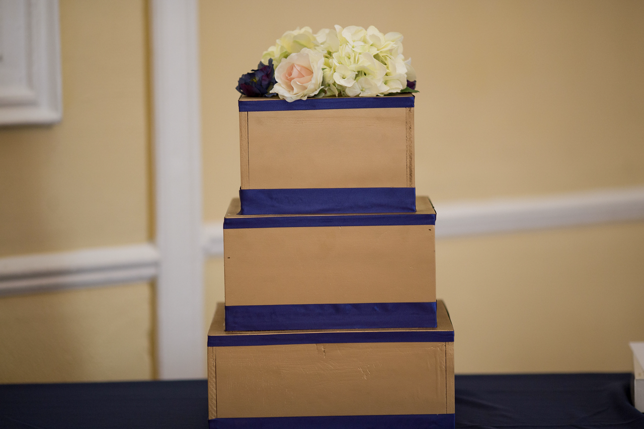 Tiered wedding cake with navy ribbon accents