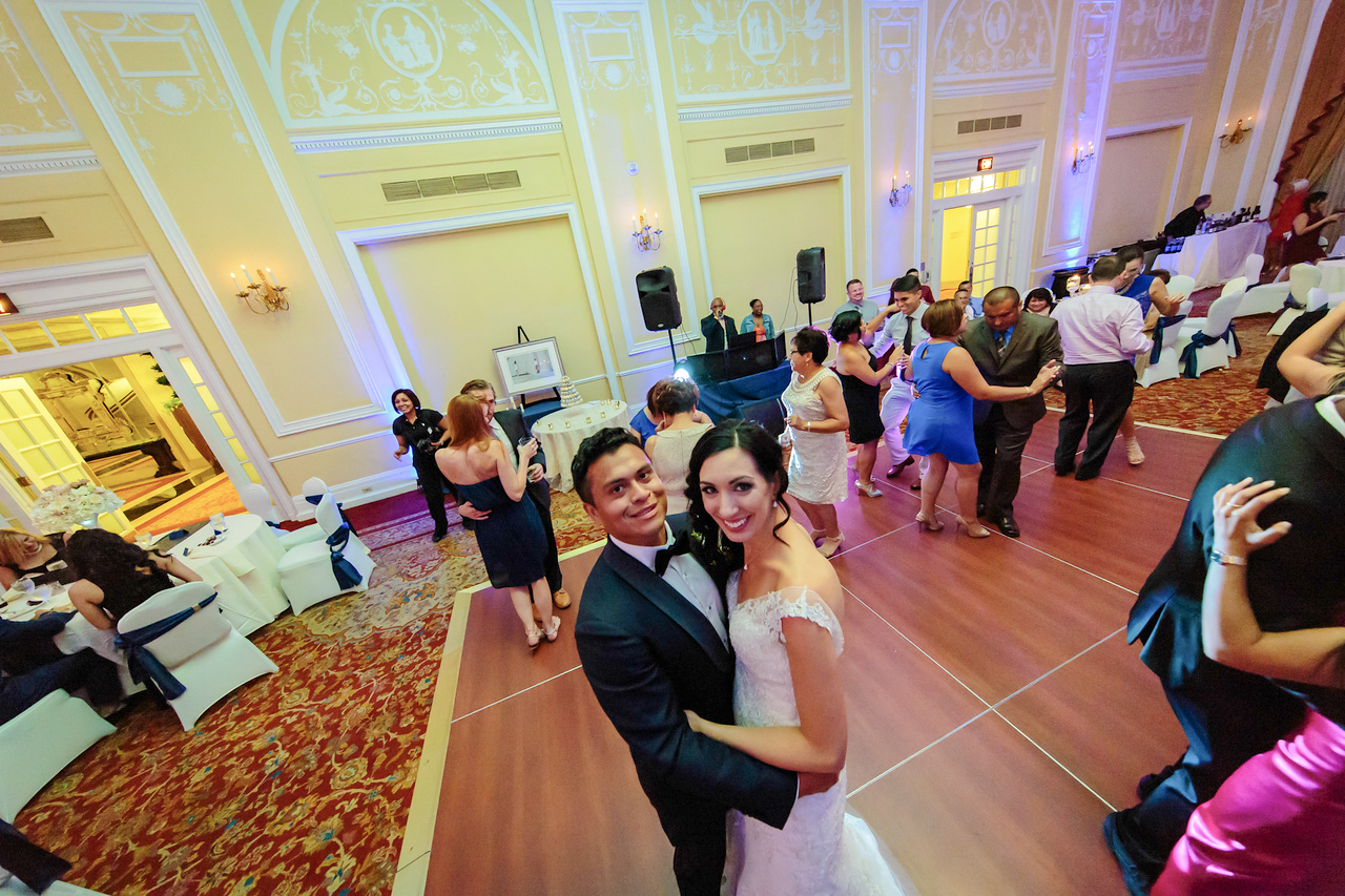Nicole and Malcolm smiling amid their reception celebration